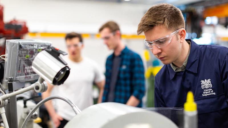 Engineer wearing safety glasses working in a manufacturing lab