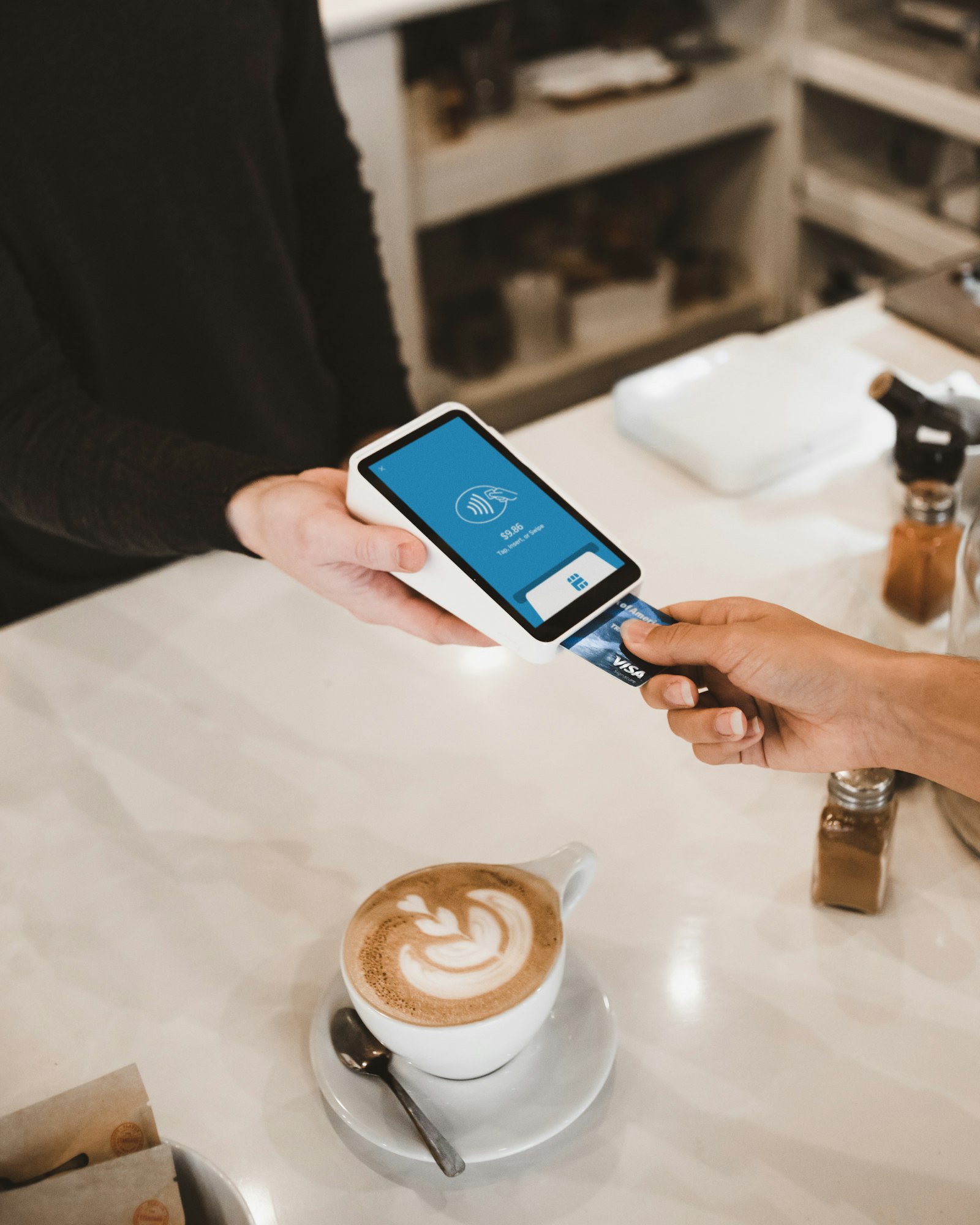 Customer tapping a card on a payment terminal