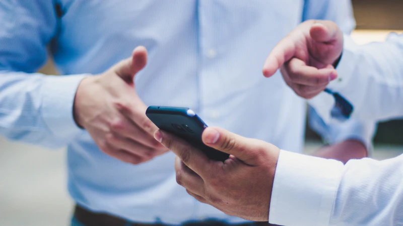 Business professionals using smartphones