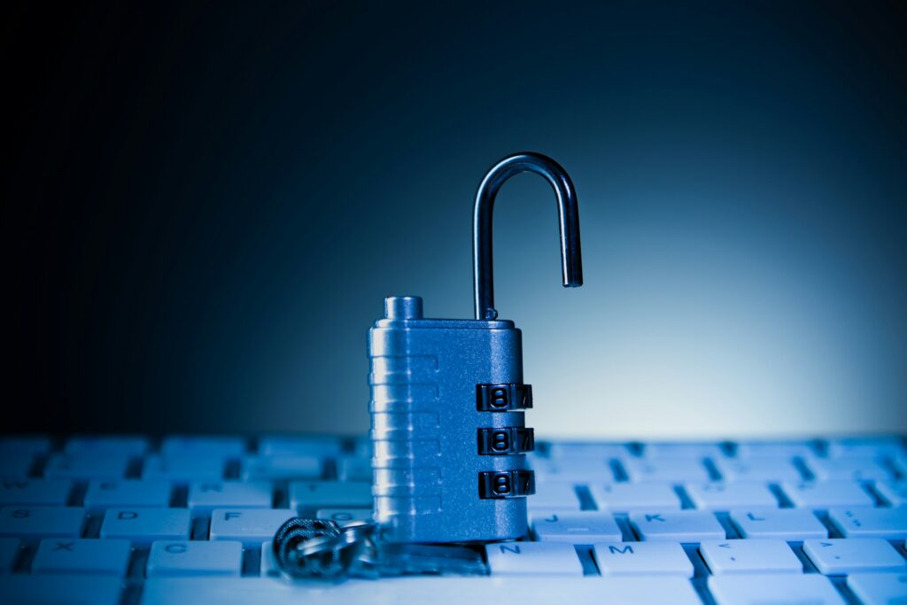 Blue padlock resting on a computer keyboard