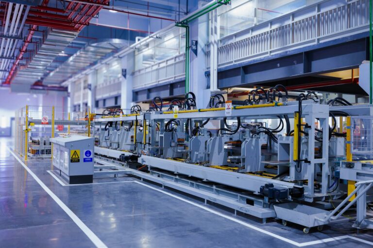 Modern factory floor with industrial machinery under bright overhead lighting