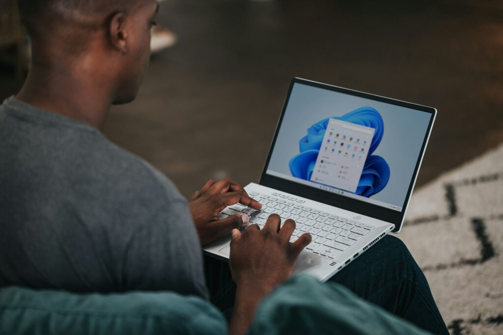 Person working on a Windows laptop in a modern office