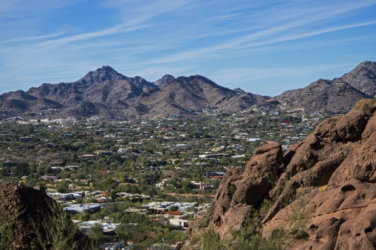 Phoenix, Arizona cityscape with mountains and downtown buildings under a blue sky